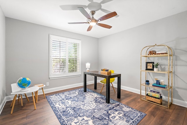 office space with baseboards, wood finished floors, and a ceiling fan