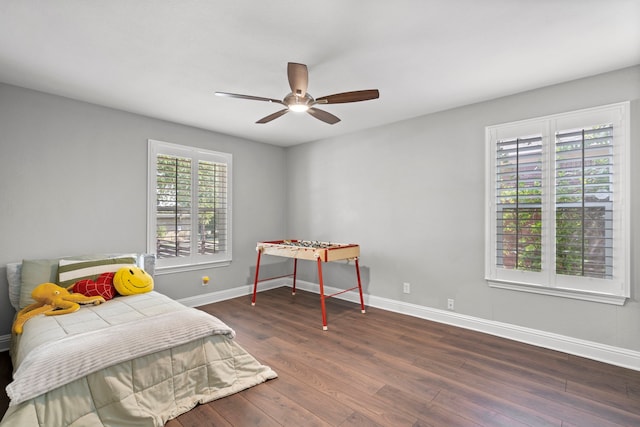 bedroom with baseboards, wood finished floors, and a ceiling fan