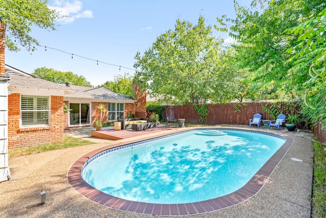 view of swimming pool with a deck and a fenced backyard