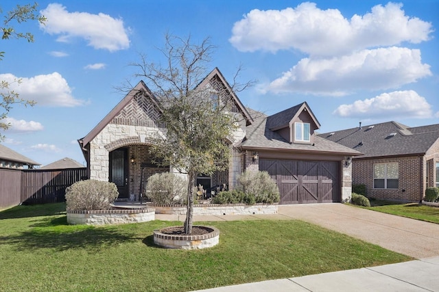 view of front of home with fence, driveway, a front lawn, a garage, and stone siding