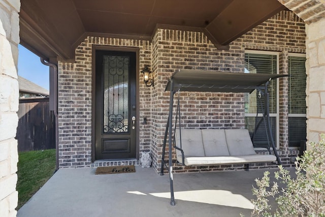 doorway to property featuring brick siding