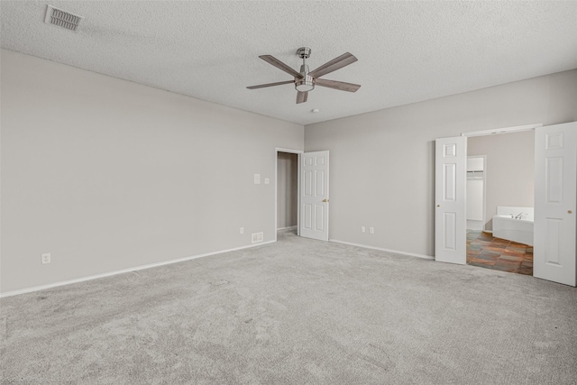 unfurnished bedroom featuring visible vents, baseboards, carpet floors, a textured ceiling, and a ceiling fan