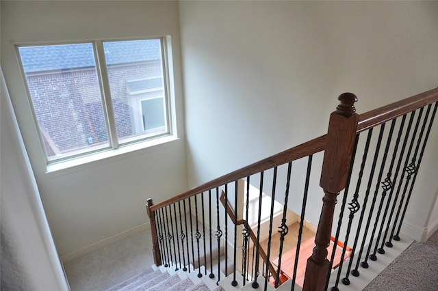 stairway with carpet flooring and baseboards