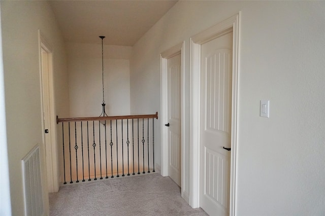 hallway with visible vents and carpet flooring