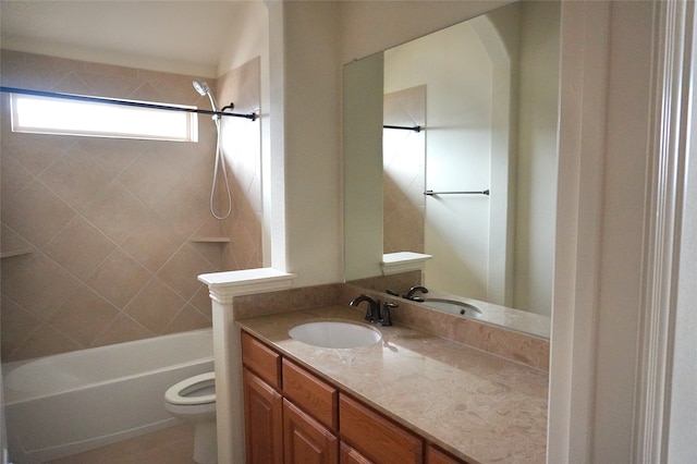 bathroom with toilet, vanity, and shower / tub combination