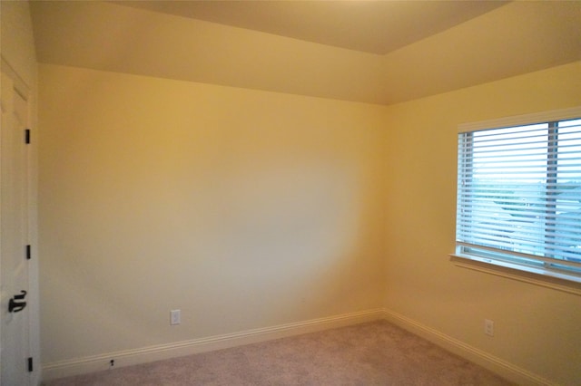 empty room with baseboards and light carpet