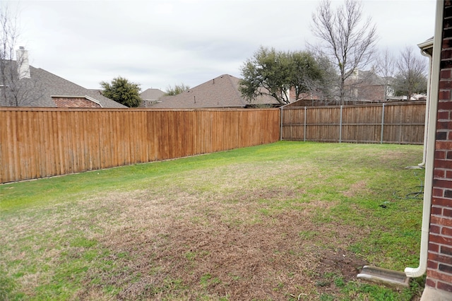 view of yard with a fenced backyard