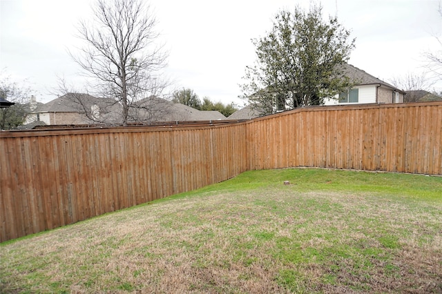 view of yard with a fenced backyard