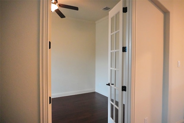 corridor with visible vents, dark wood-style floors, french doors, crown molding, and baseboards