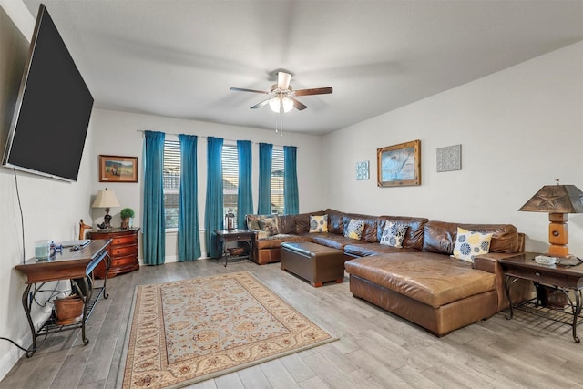 living area with light wood-style flooring and a ceiling fan