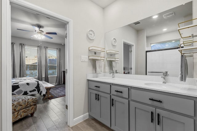 ensuite bathroom featuring visible vents, ensuite bathroom, a sink, ceiling fan, and wood tiled floor