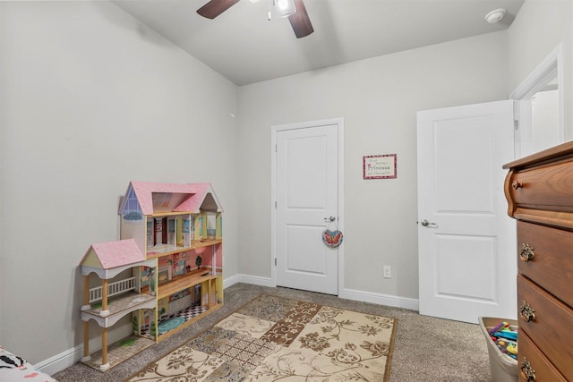 rec room with baseboards, carpet floors, and ceiling fan