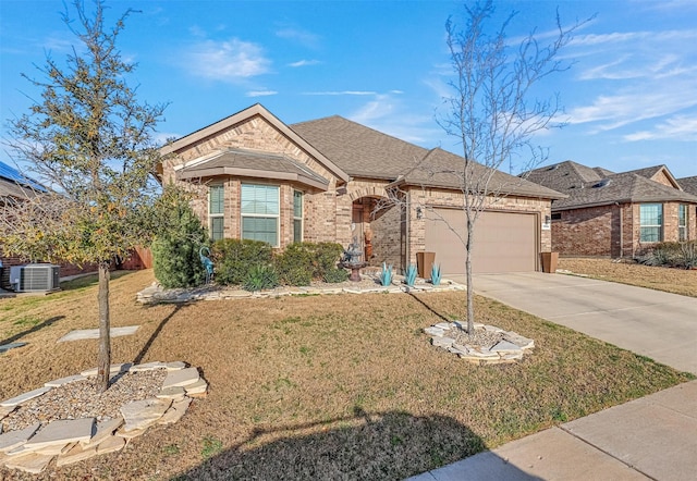 view of front of home featuring driveway, roof with shingles, an attached garage, a front lawn, and brick siding