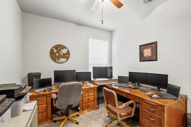 office featuring visible vents, light colored carpet, and ceiling fan