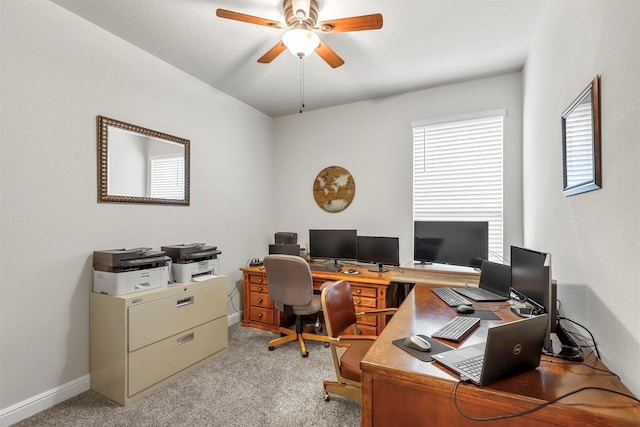 home office featuring light carpet, baseboards, and ceiling fan