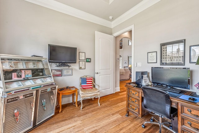 office featuring arched walkways, wood finished floors, and crown molding