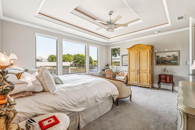 bedroom with light carpet, visible vents, a raised ceiling, and ornamental molding