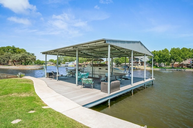 view of dock with a yard, a water view, and boat lift