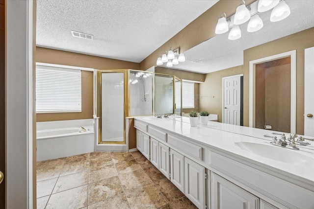 full bath featuring double vanity, visible vents, a shower stall, and a sink