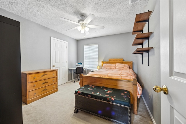 bedroom featuring baseboards, carpet, a ceiling fan, and a textured ceiling