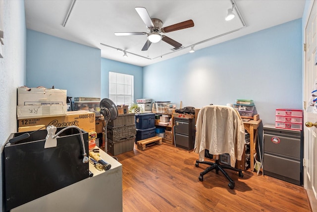 office space featuring ceiling fan, wood finished floors, and track lighting