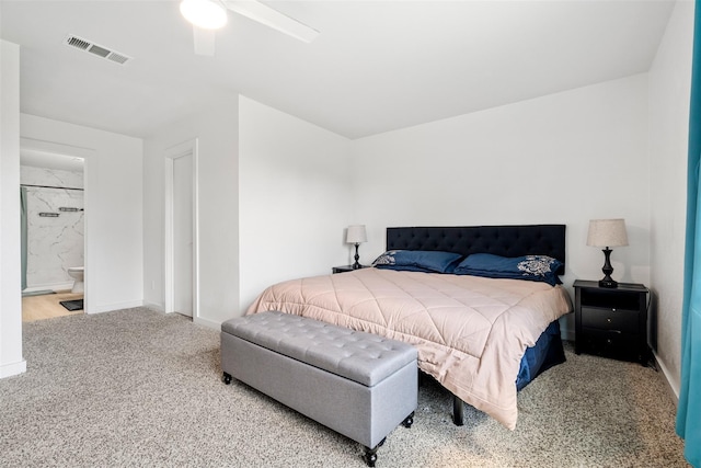 carpeted bedroom featuring a ceiling fan, visible vents, ensuite bathroom, and baseboards