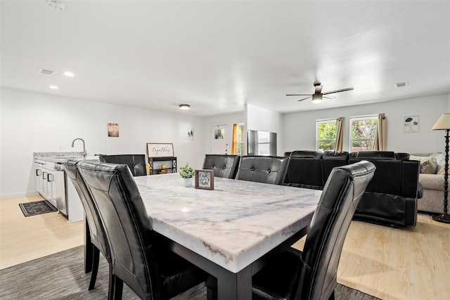 dining space with light wood-style flooring, recessed lighting, a ceiling fan, and visible vents