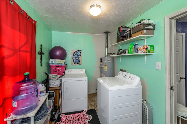 laundry room with independent washer and dryer, laundry area, water heater, and a textured ceiling