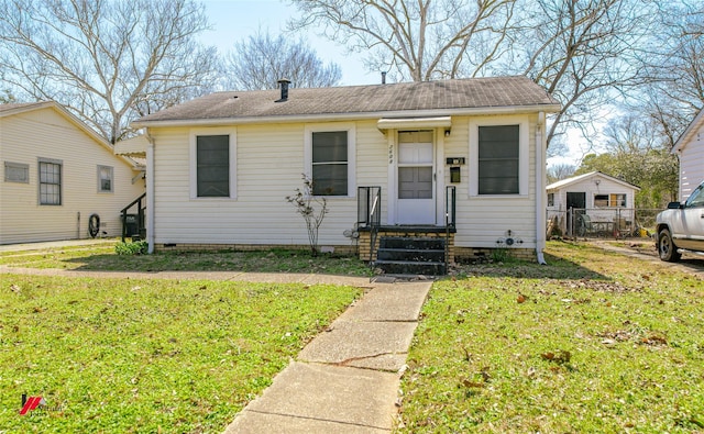 bungalow-style house featuring crawl space, entry steps, a front yard, and fence