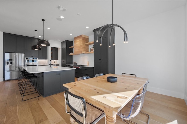 dining area with recessed lighting, visible vents, baseboards, and light wood-style flooring