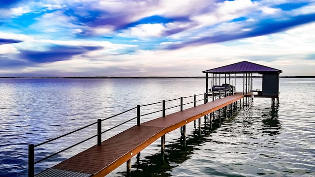 view of dock with boat lift and a water view