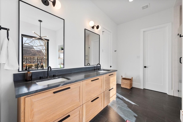 full bathroom with double vanity, visible vents, baseboards, and a sink