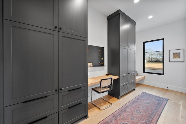 interior space with light wood-style flooring, recessed lighting, and baseboards