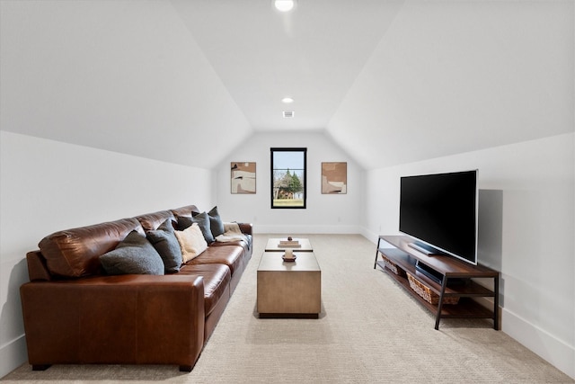 living area with baseboards, light carpet, lofted ceiling, and visible vents