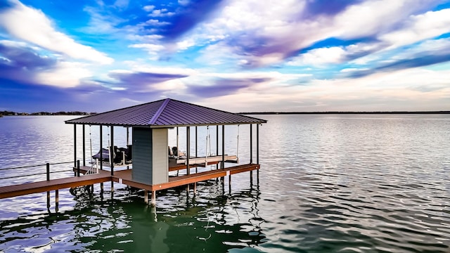 dock area with a water view and boat lift