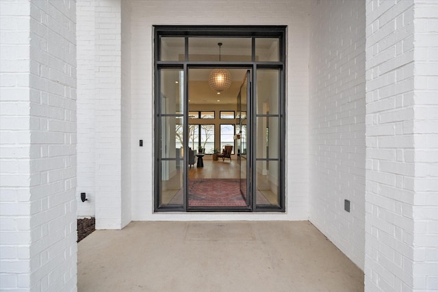 entrance to property featuring brick siding