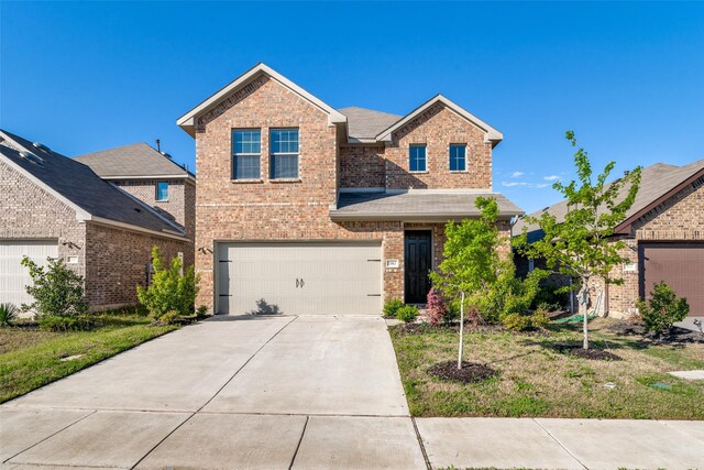 traditional home featuring brick siding, concrete driveway, a garage, and roof with shingles