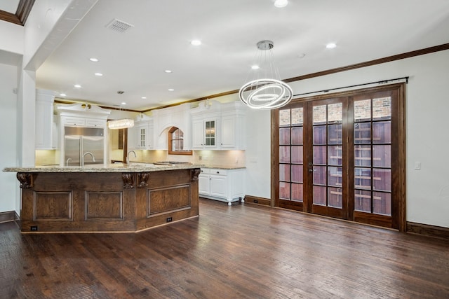 kitchen with stainless steel appliances, ornamental molding, baseboards, glass insert cabinets, and white cabinetry