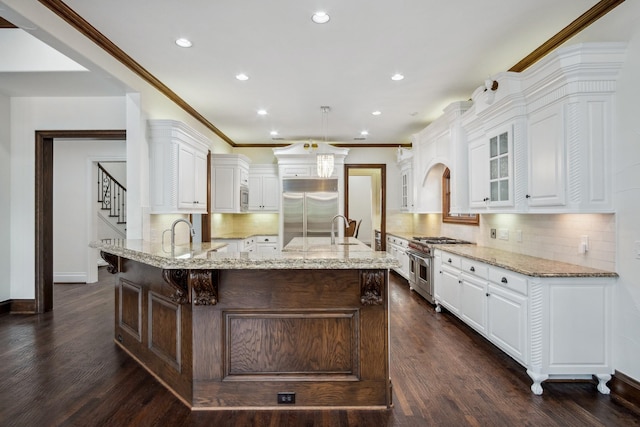kitchen featuring high quality appliances, a sink, glass insert cabinets, baseboards, and white cabinetry