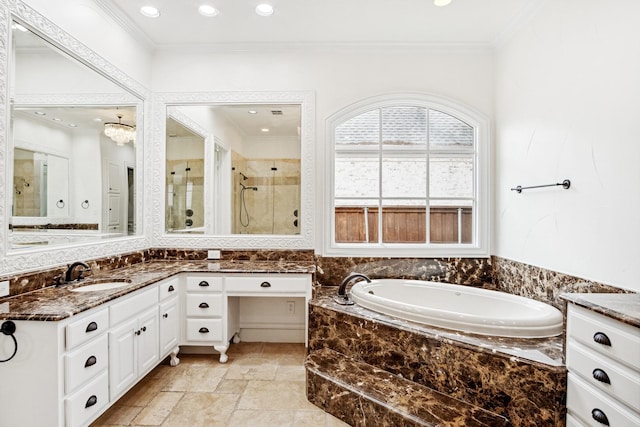 bathroom featuring a shower stall, crown molding, vanity, a bath, and recessed lighting