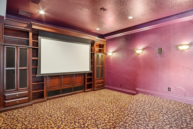 carpeted cinema room with a textured ceiling, crown molding, and recessed lighting