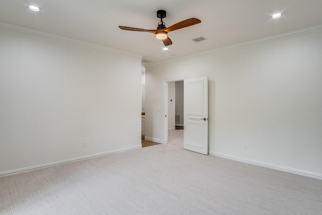 unfurnished room featuring light colored carpet, crown molding, a ceiling fan, recessed lighting, and baseboards