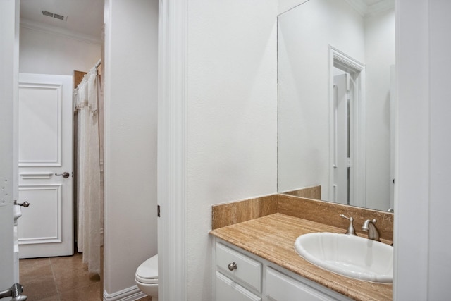 bathroom with ornamental molding, vanity, toilet, and tile patterned flooring