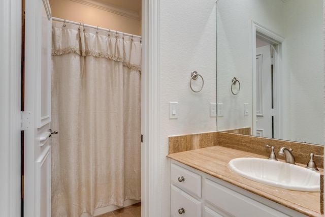 full bathroom with crown molding, vanity, and curtained shower