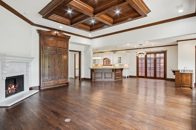 unfurnished living room with ornamental molding, dark wood-type flooring, a fireplace, baseboards, and recessed lighting