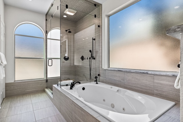 full bath featuring tile patterned flooring, a stall shower, and a whirlpool tub