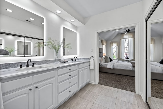 ensuite bathroom featuring ceiling fan, ensuite bath, visible vents, and a sink