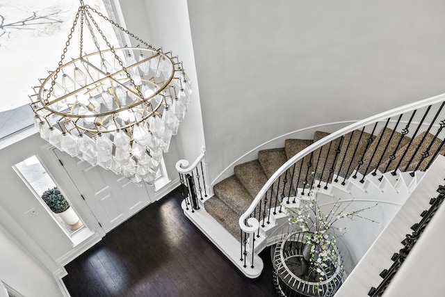 entryway with stairway, baseboards, and dark wood-style flooring