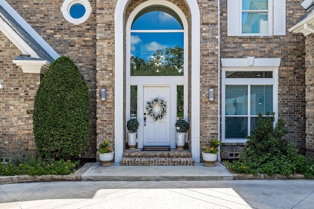 doorway to property with brick siding