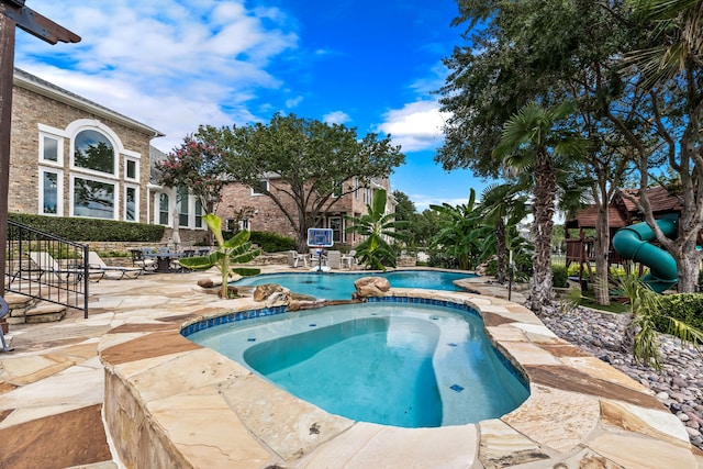 view of swimming pool featuring a patio area, a fenced in pool, and an in ground hot tub